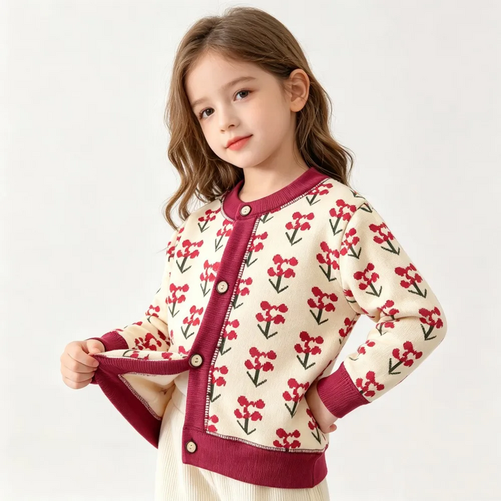 Child showing the button front of a cream floral cardigan with burgundy trim