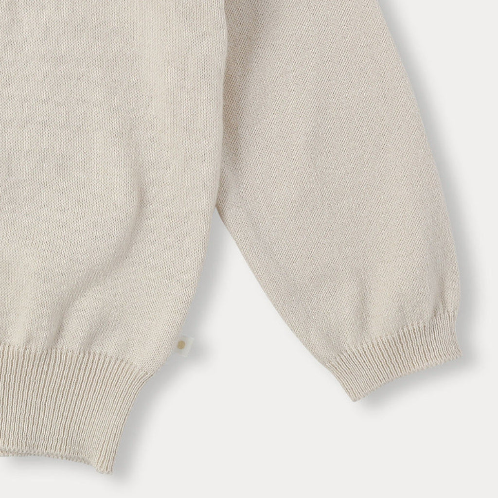 Close-up of the cream sweater&