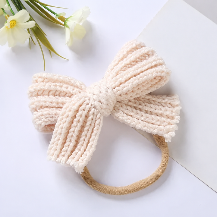 Cream knitted bow headband with a slim beige stretch band
