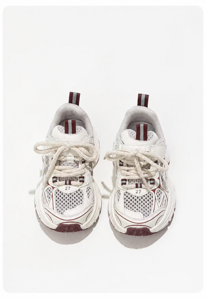 Front view of white mesh sneakers with cream laces and bordeaux toe accents
