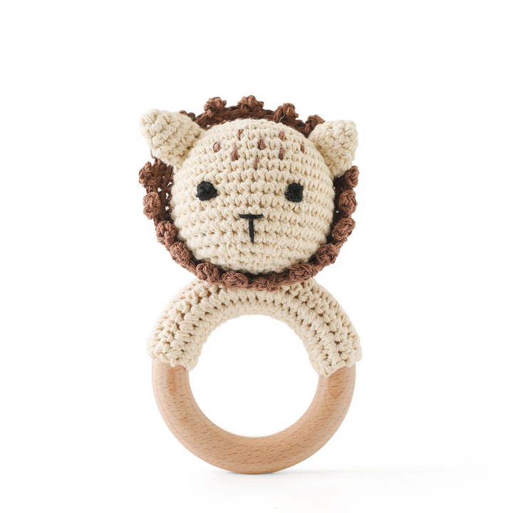 Cream crocheted lion rattle with a brown mane and wooden ring