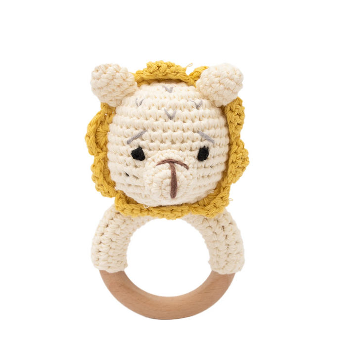 Cream crocheted lion rattle with a yellow mane and natural wooden ring