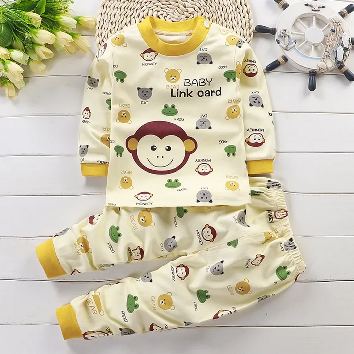 Cream monkey-print pajama set with yellow trim and a large monkey graphic on the top