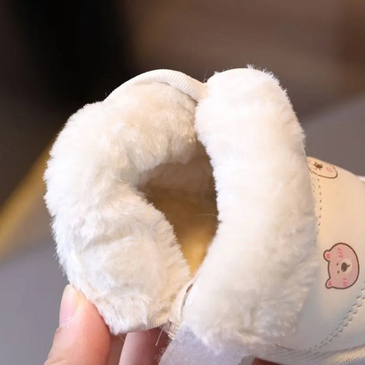 Close-up of the cream plush lining inside an animal-print ankle boot