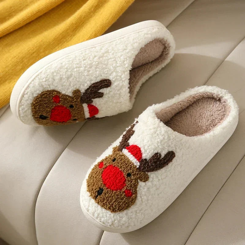Red-nosed reindeer slippers resting on a sofa with their plush lining visible.
