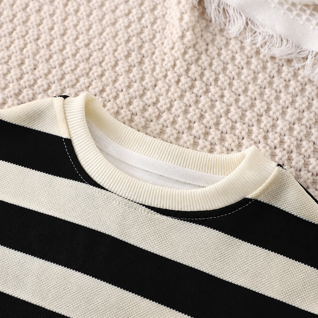 Close-up of the cream ribbed crewneck and black-and-cream stripes on the T-shirt