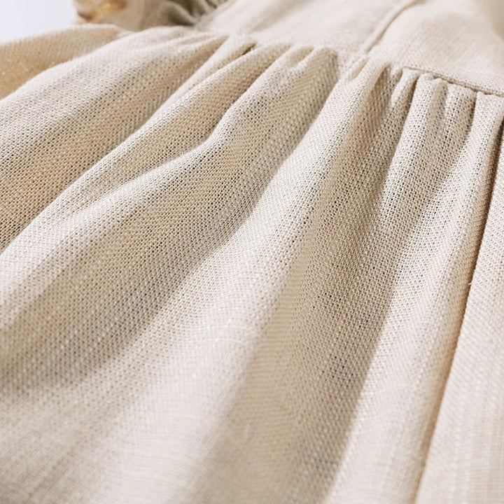 Close-up of the cream rayon-and-linen fabric at the romper&