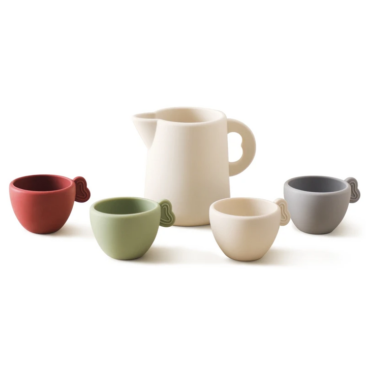 Basic toy tea set with a cream pitcher and four cups in red, green, cream, and gray