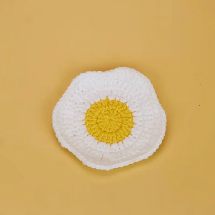Fried egg design coaster with a white crocheted edge and round yellow center