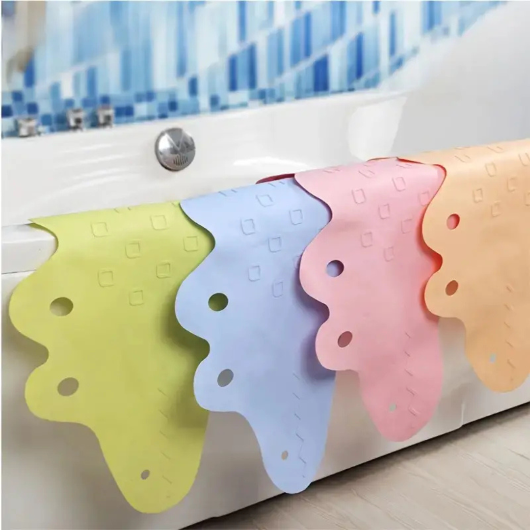 Crocodile bath mats in several colors draped over the edge of a bathtub