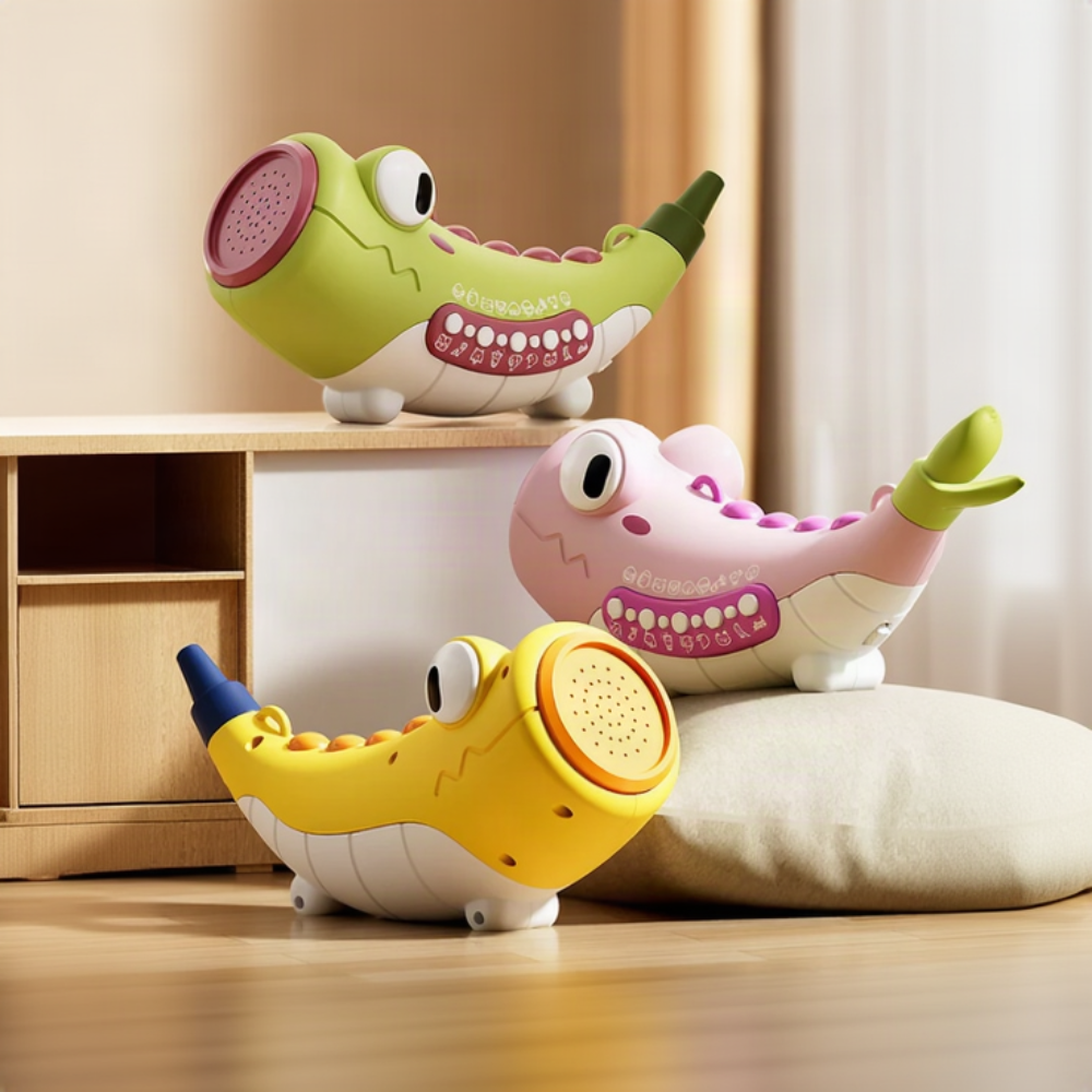 Green, pink and yellow crocodile-shaped sound toys with buttons and horn openings