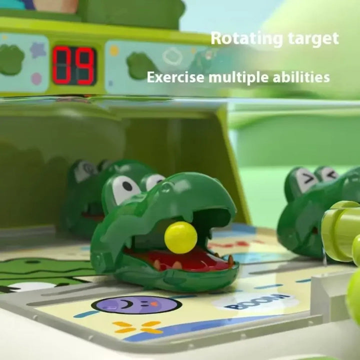 Close-up of a crocodile target holding a yellow ball beneath the digital scoreboard