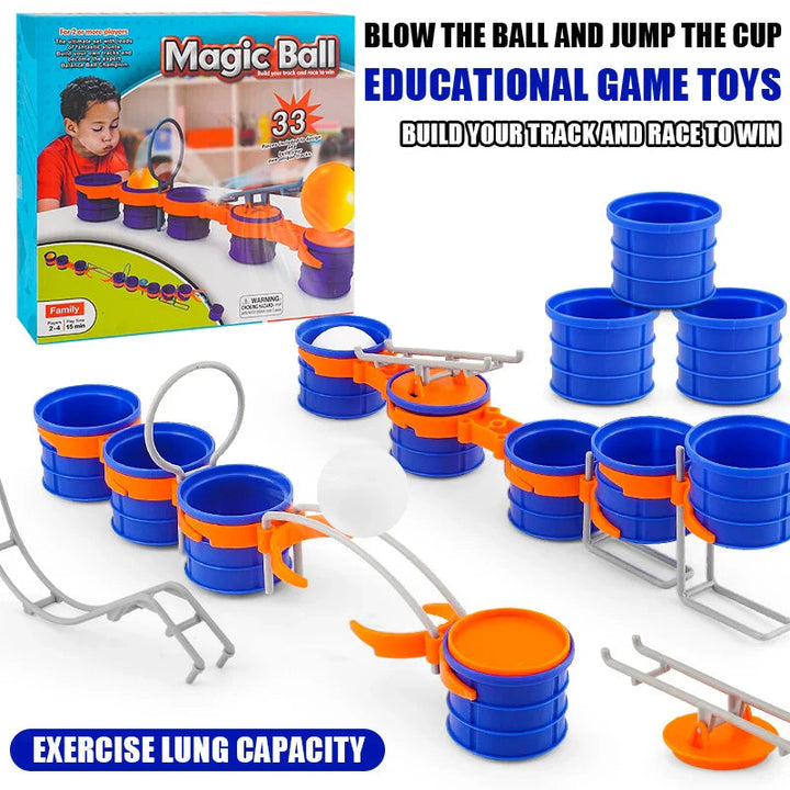 Cup-and-ball game set with blue cups, white balls, orange connectors, gray obstacles and packaging