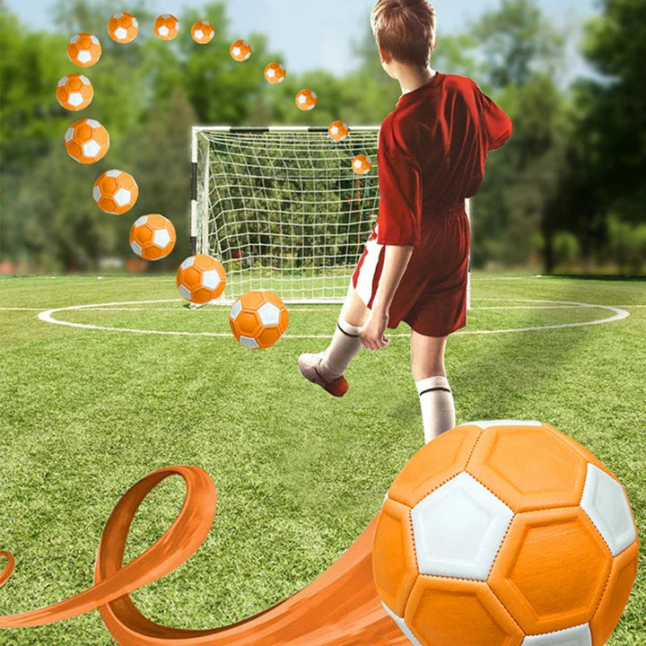 Child kicking a soccer ball toward a goal with an illustrated curved flight path.
