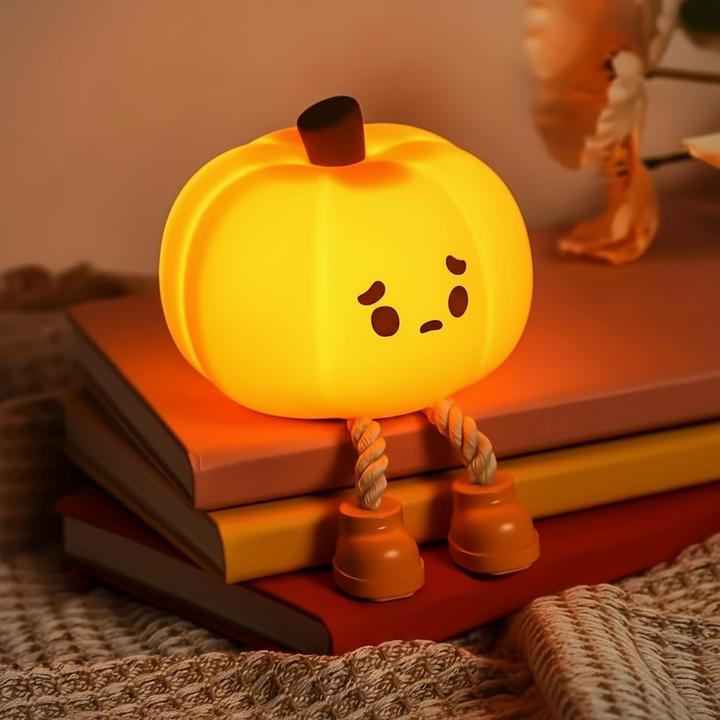 Glowing cute pumpkin light perched on books with orange boots and rope legs