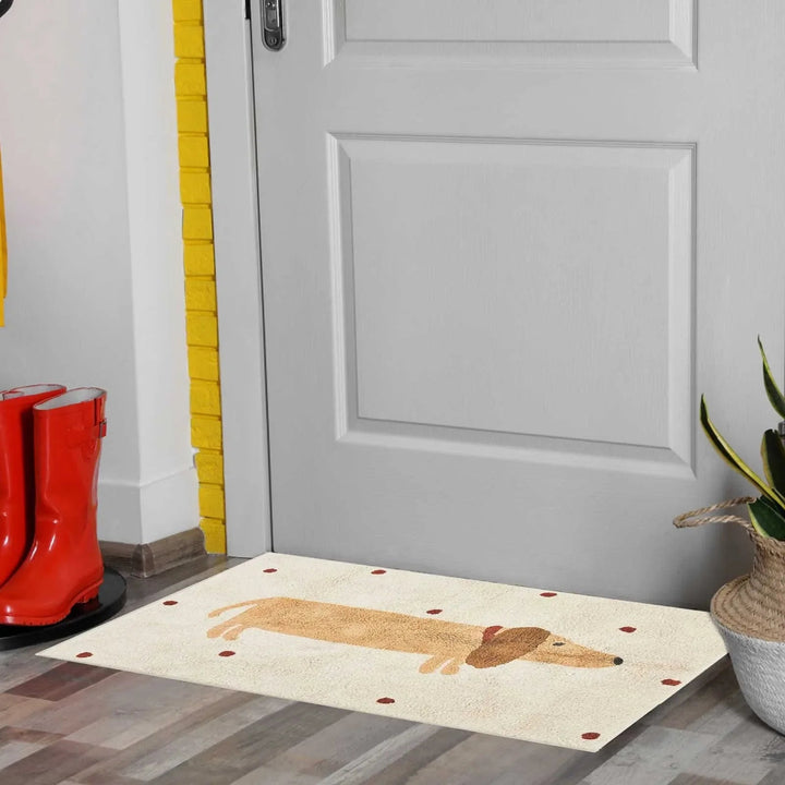 Beige dachshund rug in front of a gray door beside red boots