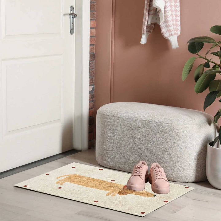 Dachshund rug near a doorway with pink shoes and a gray ottoman