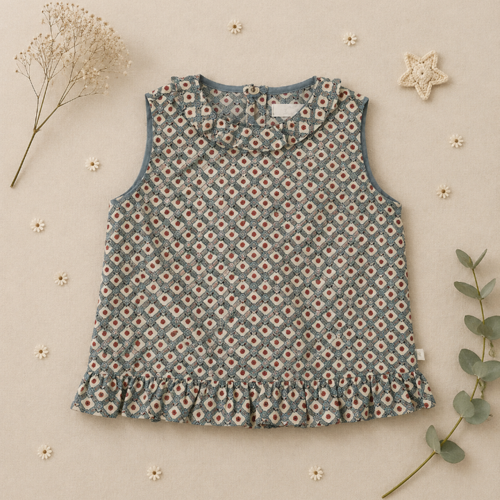 Back of the daisy-print blouse showing button closures and a ruffled hem
