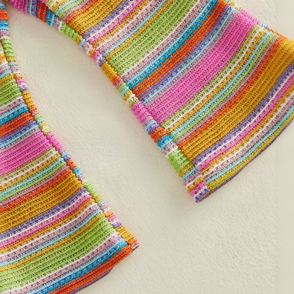 Close-up of the multicolor striped fabric and wide flared pant hems.