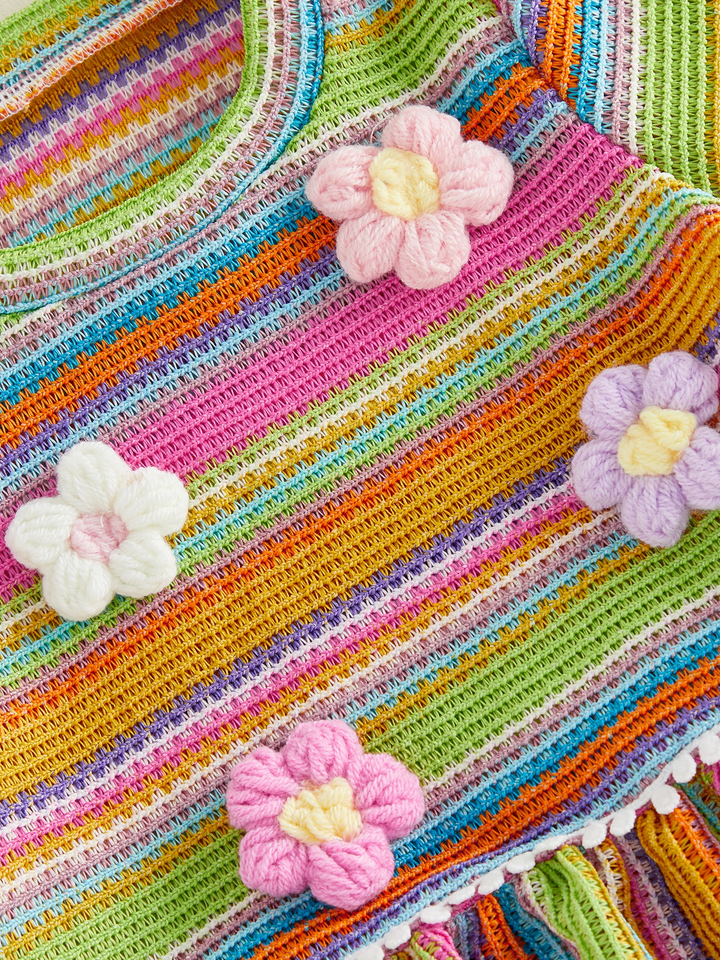 Raised pink, white, and lilac flowers on the multicolor striped top.