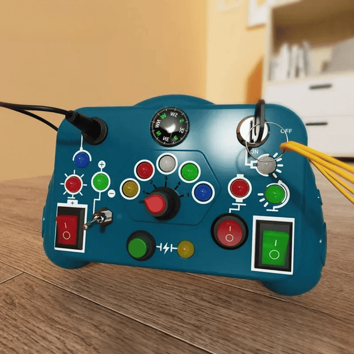 Dark blue activity board with colorful buttons, a rotary dial, key, and rocker switches