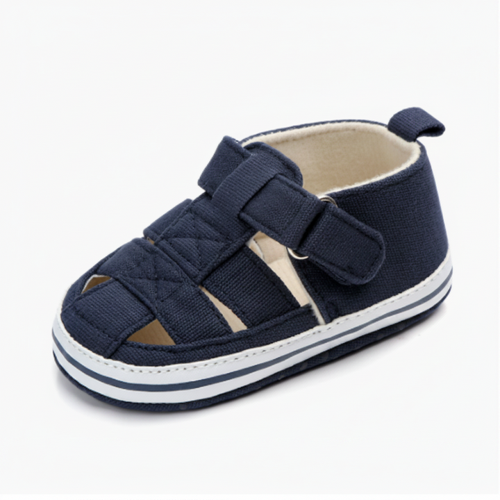 Dark blue baby sandal with a side strap and white sole