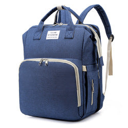 Dark blue diaper backpack with front zip pocket, top handles and shoulder straps