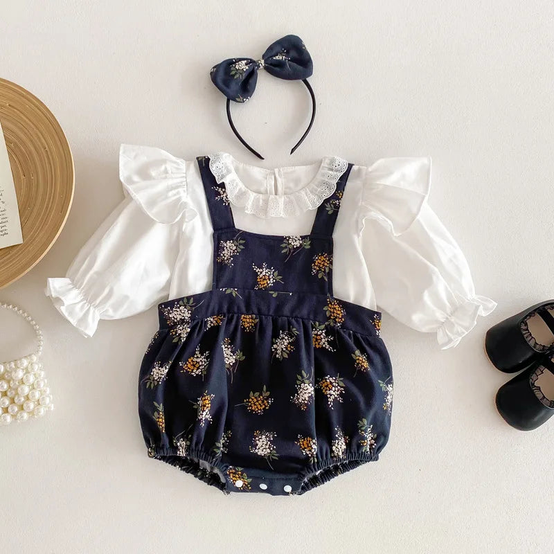 Dark blue floral bodysuit with a white ruffled top and matching bow headband