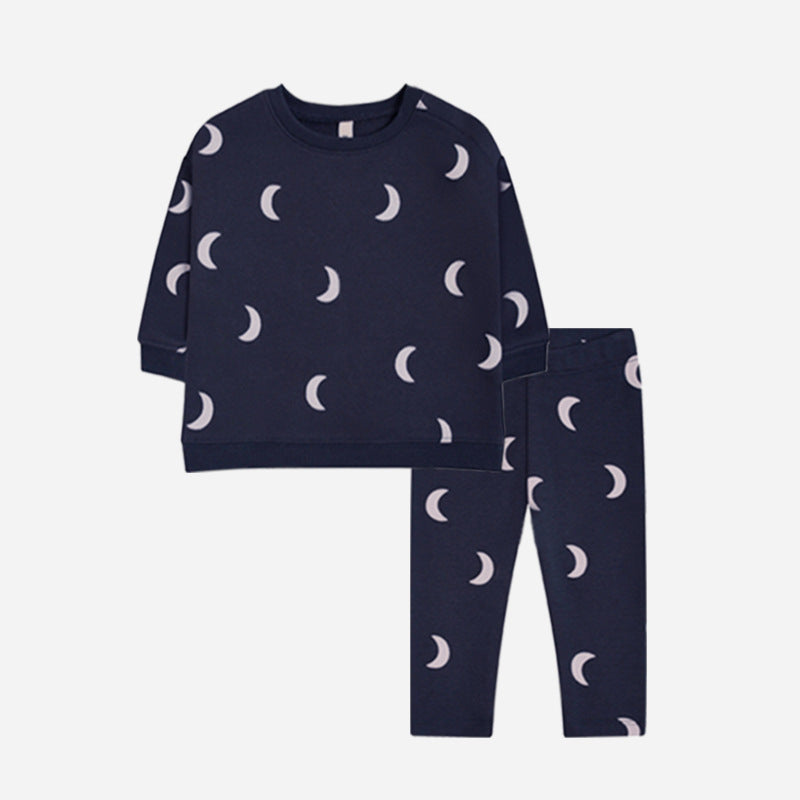 Dark pajama set with light crescent moons on the long-sleeve sweater and matching pants.