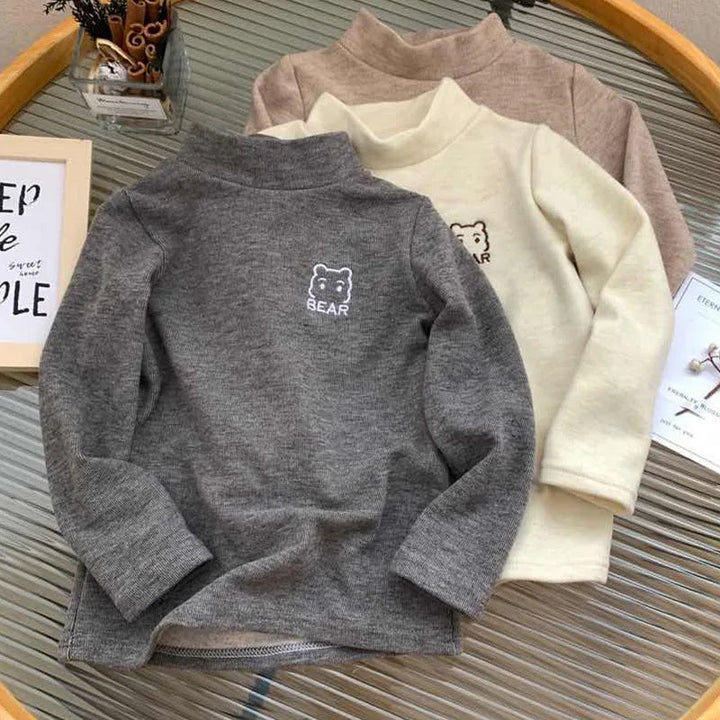 Dark gray bear fleece shirt in front of beige and khaki color options