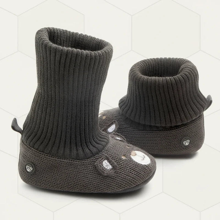 Dark gray knit baby booties showing one cuff extended and one folded over.
