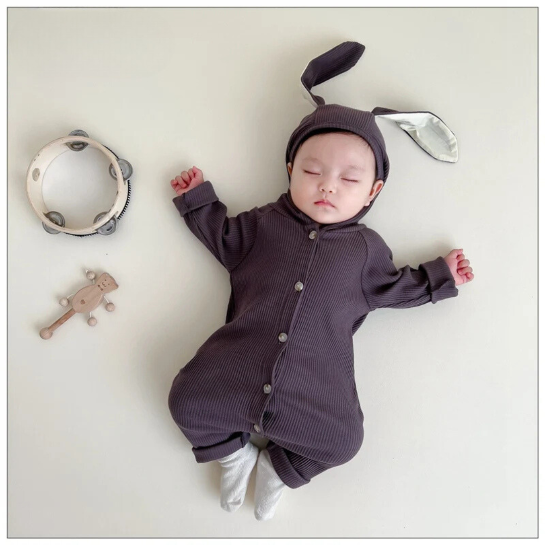 Baby wearing the dark gray bunny-ear romper with a button front