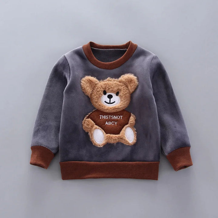 Dark gray pullover with a textured teddy-bear patch and brown collar, cuffs, and hem