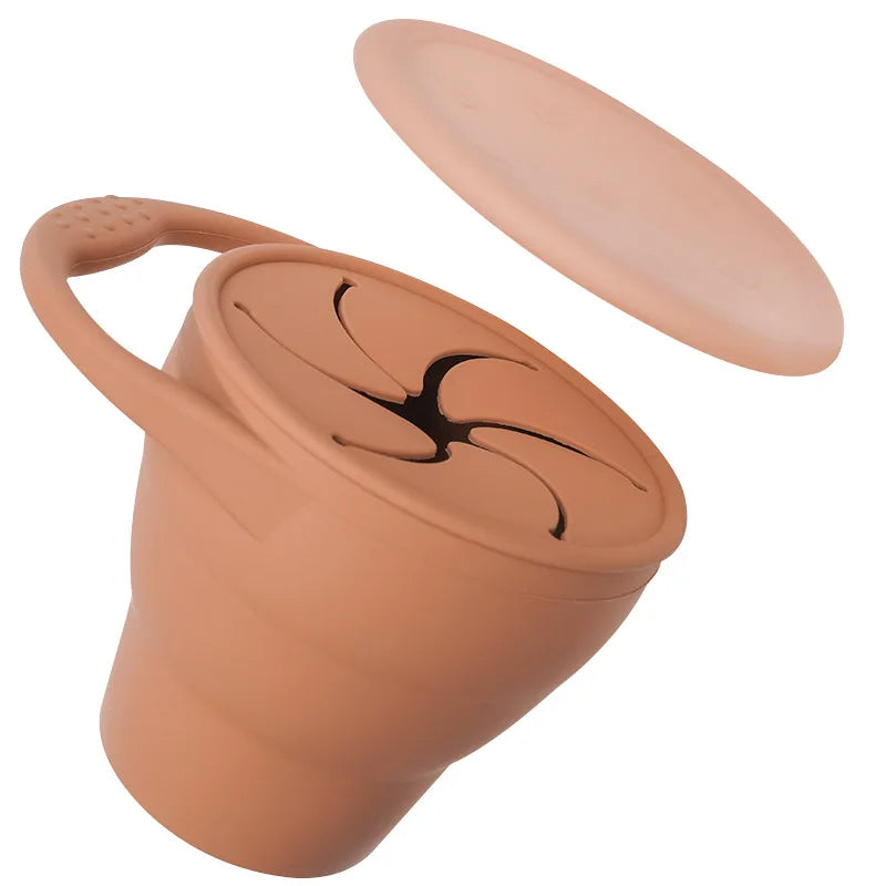 Dark orange silicone snack cup with a petal-style opening and matching cover