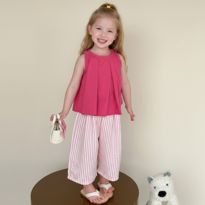 Child wearing a dark pink sleeveless top with pink-and-white striped cropped pants