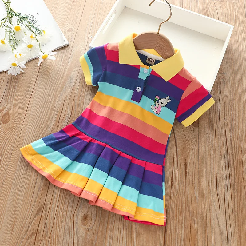 Dark Rainbow polo dress with a yellow collar, bold stripes and pleated skirt