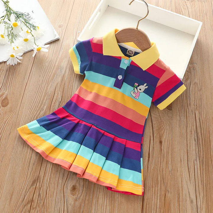 Dark Rainbow polo dress with a yellow collar, bold stripes and pleated skirt