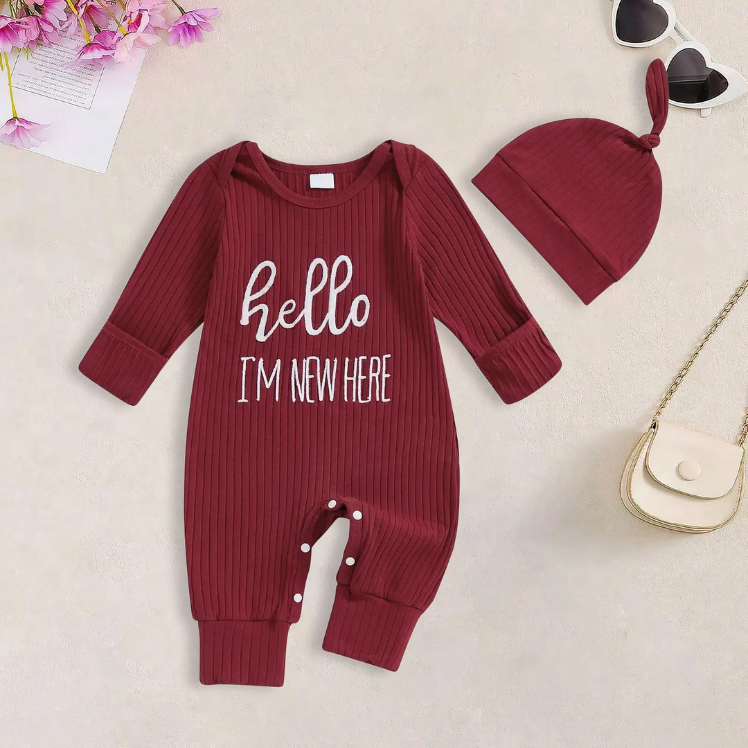 Dark red ribbed baby jumpsuit with white hello lettering and a matching knotted beanie