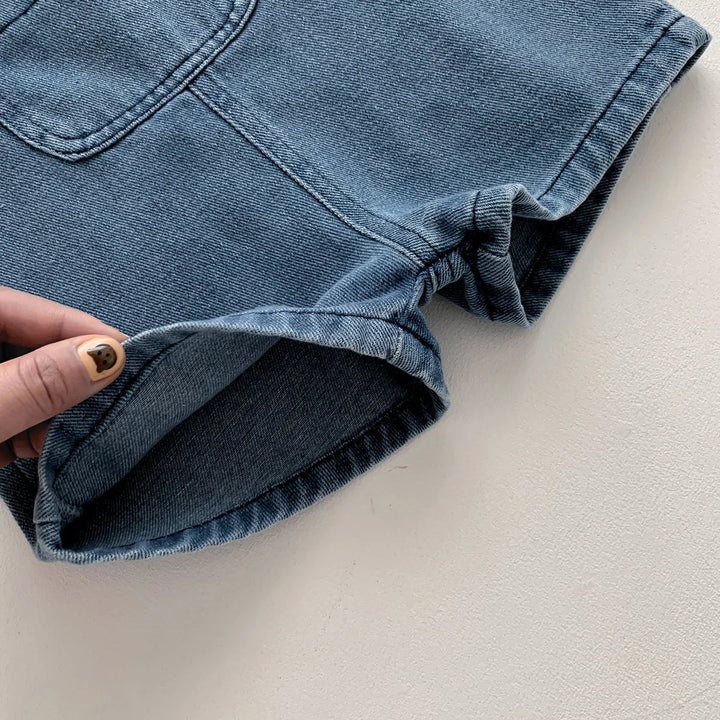 Close-up of the denim short overalls&