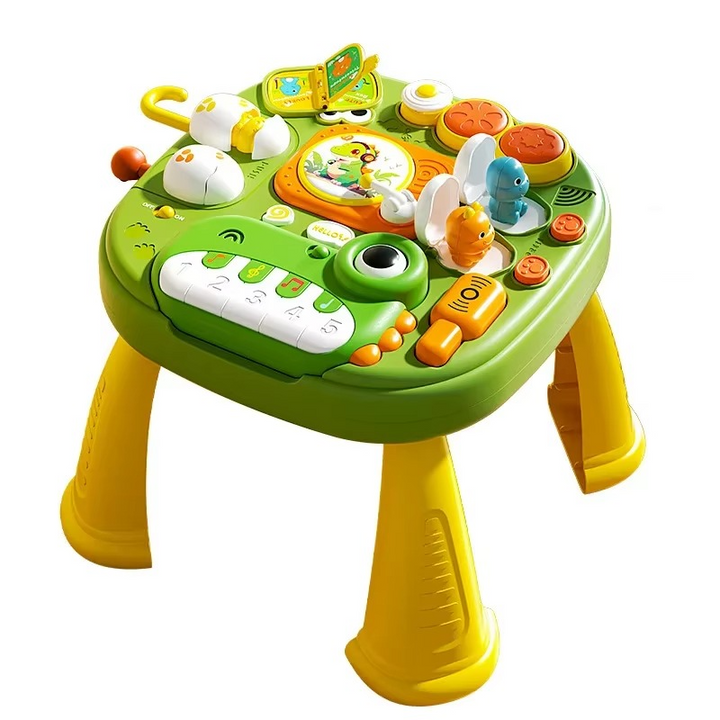 Green musical activity table with a frog-shaped piano, colorful play controls, and yellow legs
