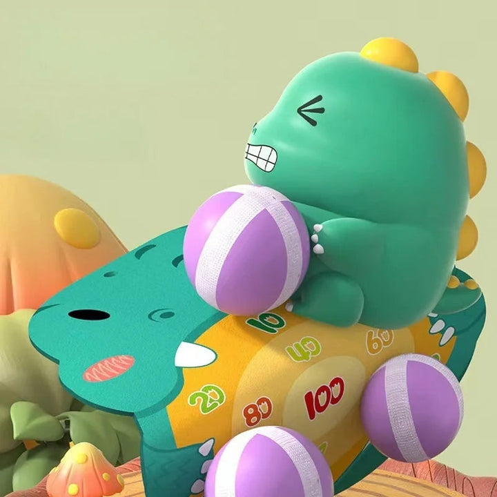 Illustrated dinosaur holding a purple ball above a numbered target with attached balls