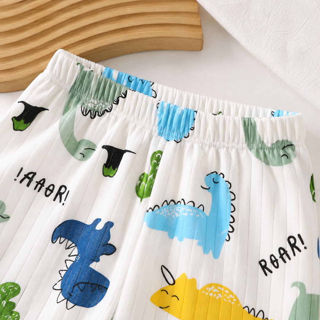 Close-up of the elastic waistband on white dinosaur-print pajama pants