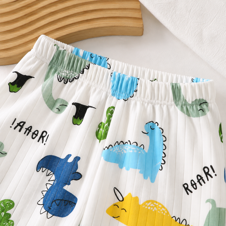 Close-up of the elastic waistband on white dinosaur-print pajama pants