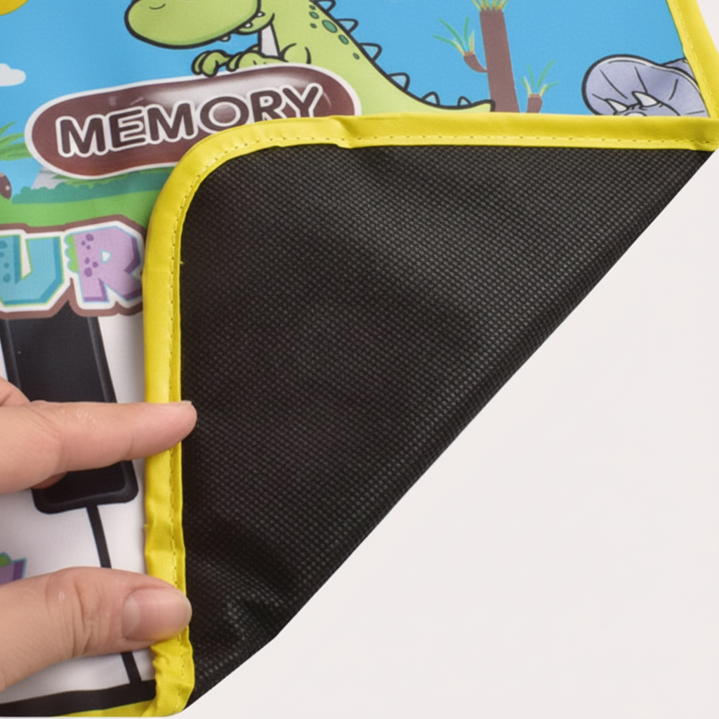 Corner of the dinosaur piano play mat lifted to show its textured black underside