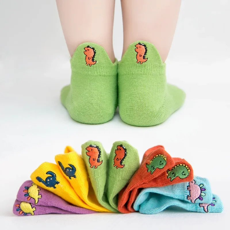Dinosaur sock set with five colorful pairs and green socks shown from the back