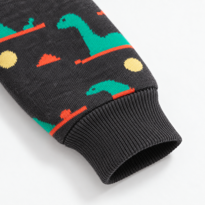 Ribbed cuff and green dinosaur pattern on a dark children&