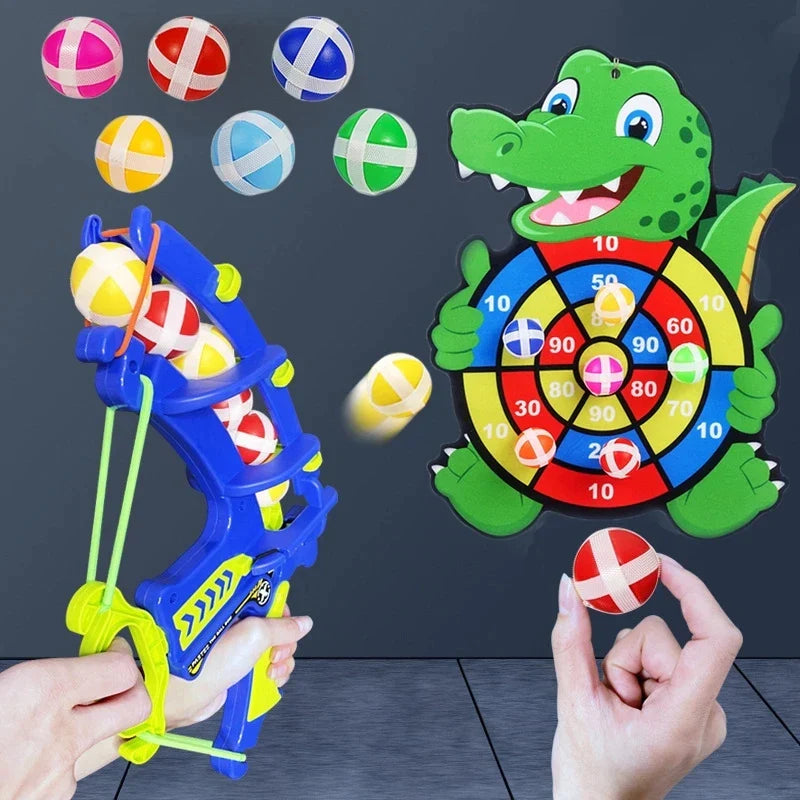 Blue bow-style launcher, colorful sticky balls, and a green dinosaur target