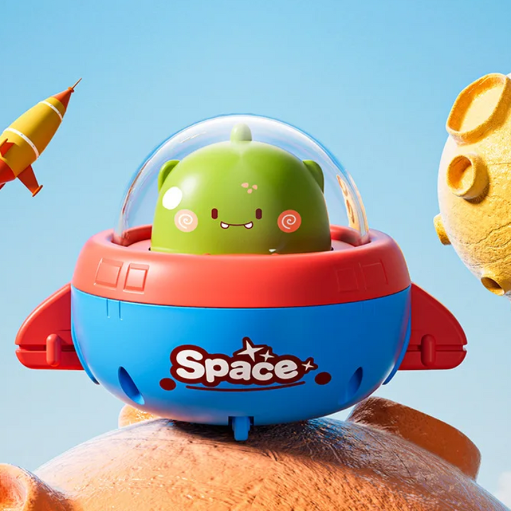 Green dinosaur pilot in a red and blue UFO toy with a clear dome.