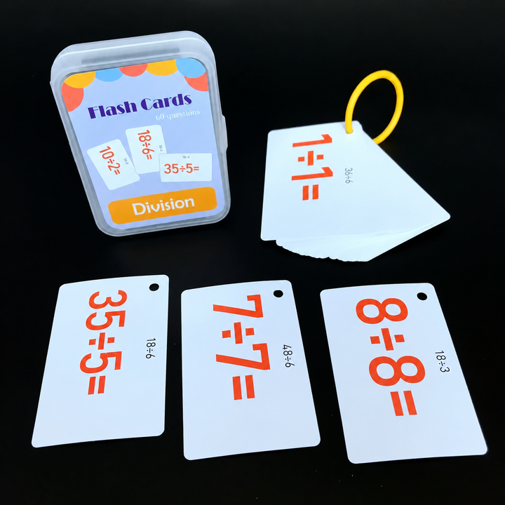 Division flash cards with orange equations, a yellow ring, and a storage case.