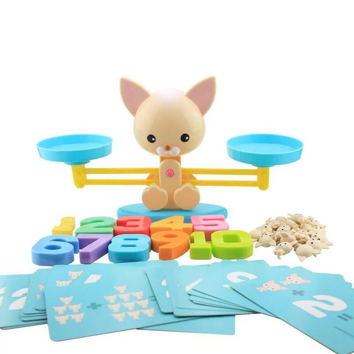 Dog counting game with numeral weights and activity cards spread in front of the scale
